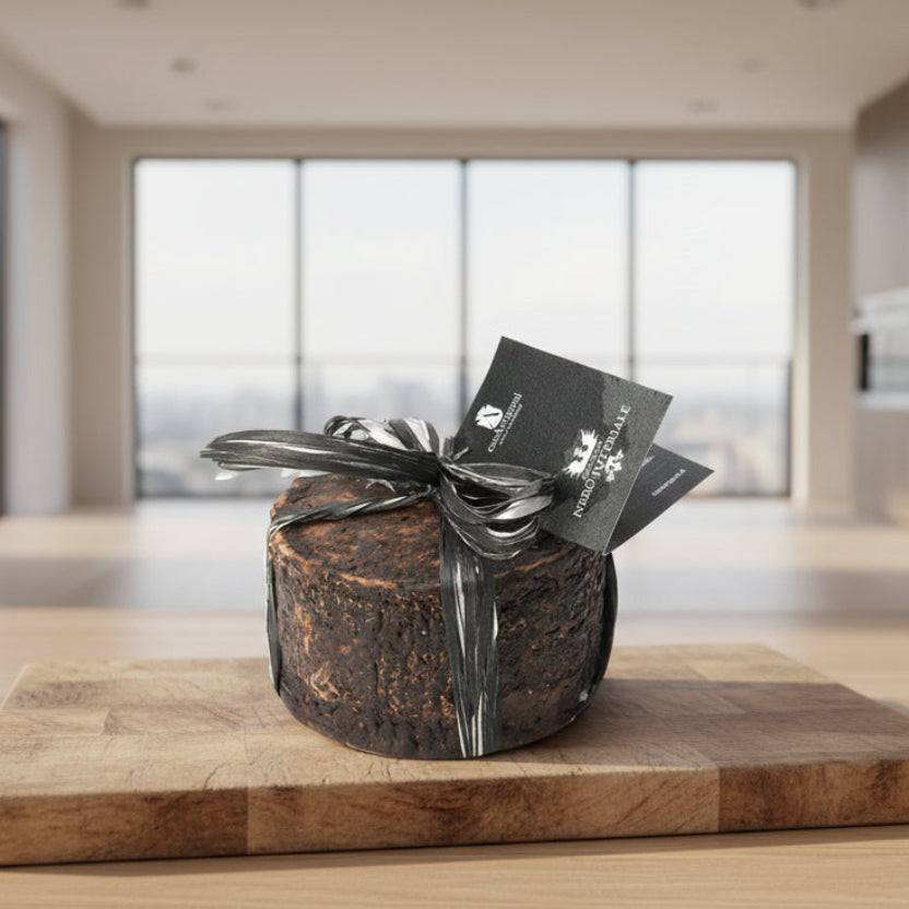 Round dark cheese with silver ribbon